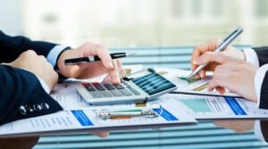 Mãos na calculadora mostram tributação para holding familiar